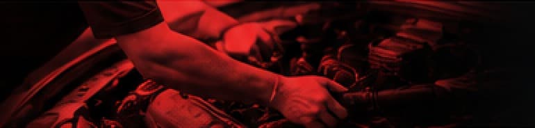 Careful hands working on a vehicle engine